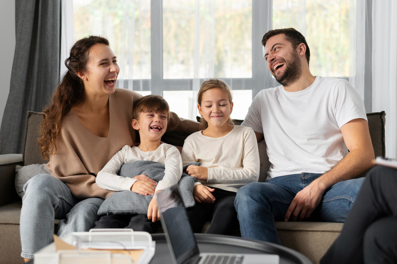 medium-shot-smiley-family-sitting-on-couch