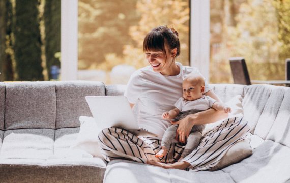 young-mother-with-her-kid-working-home-computer